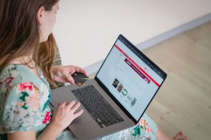 Bad money habits – woman shopping online with a laptop and credit card