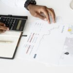 Bonds – person analyzing investment documents with a calculator