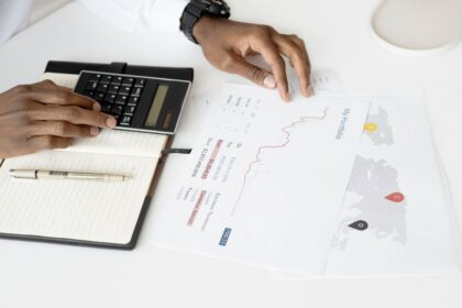 Bonds – person analyzing investment documents with a calculator