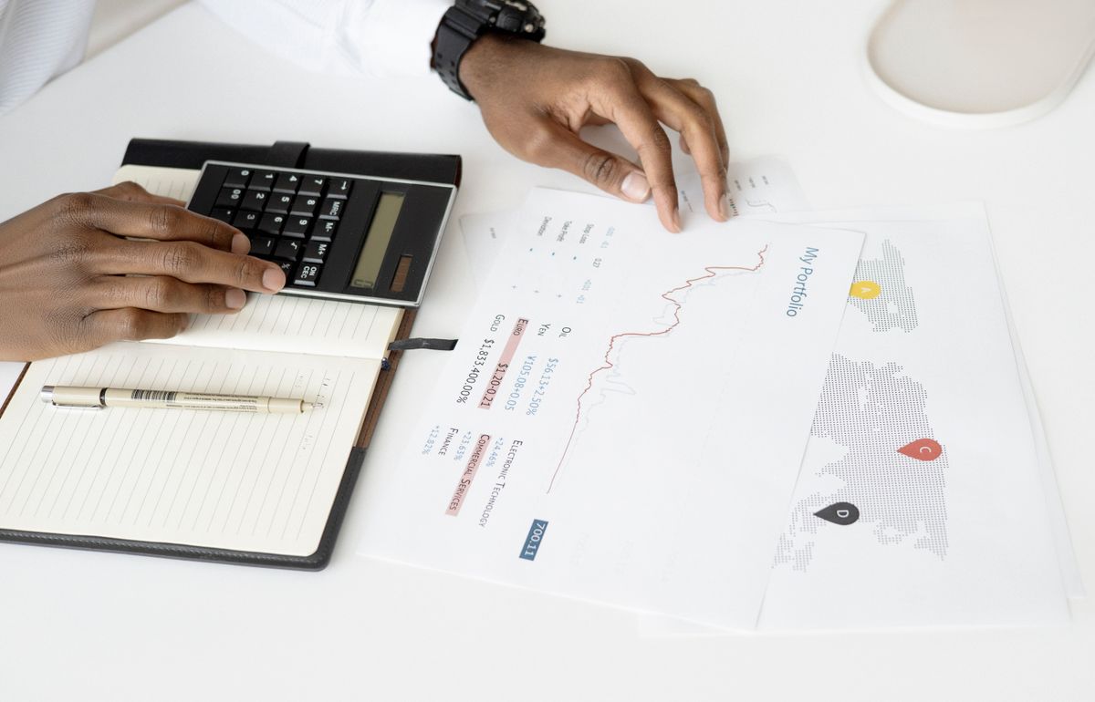 Bonds – person analyzing investment documents with a calculator