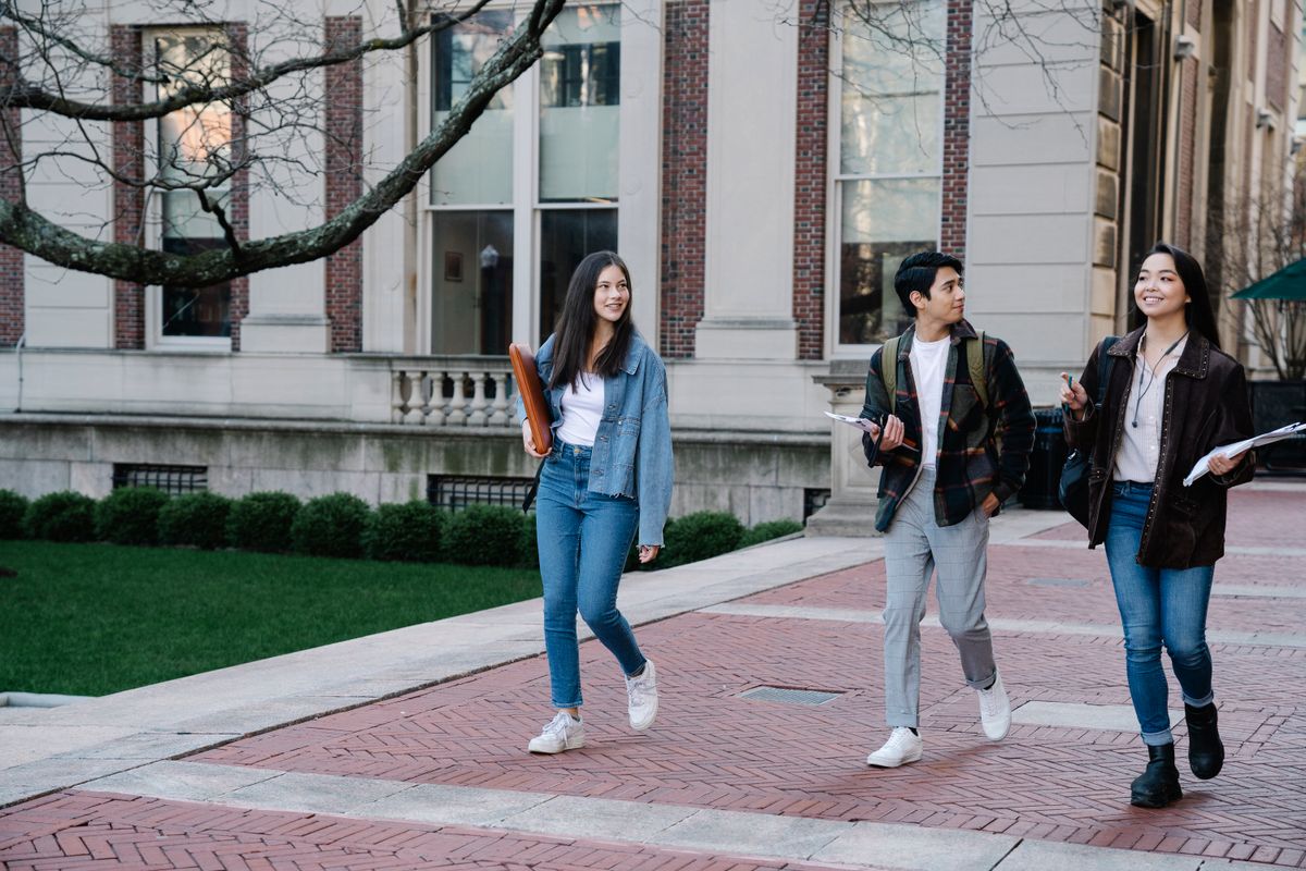 Build credit in college – students walking on a university campus