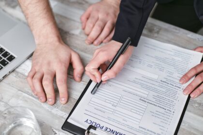 Disability insurance – two people signing an insurance policy