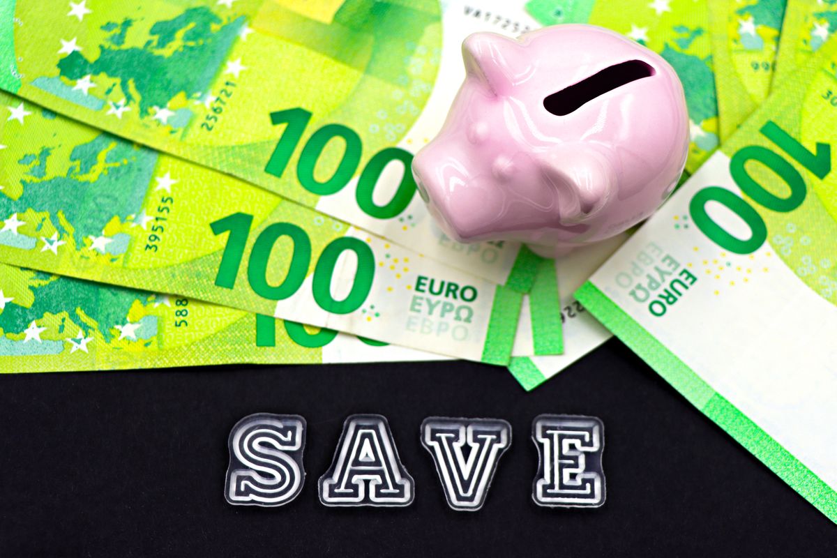 Emergency fund – piggy bank on cash with the word save