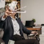 Entry-level salary – young professional calculating finances in an office
