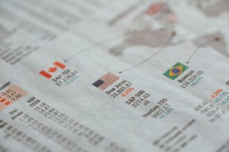 ETFs vs mutual funds – newspaper showing global financial market statistics