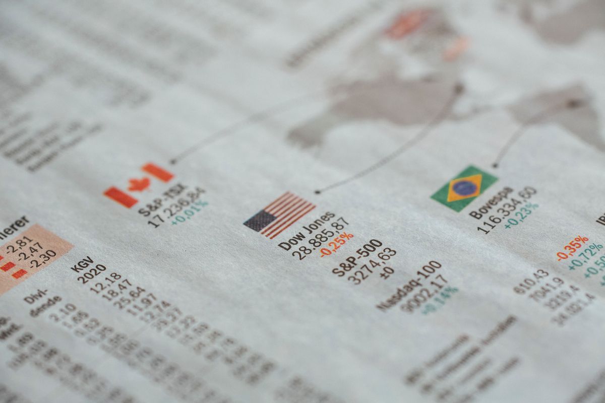 ETFs vs mutual funds – newspaper showing global financial market statistics