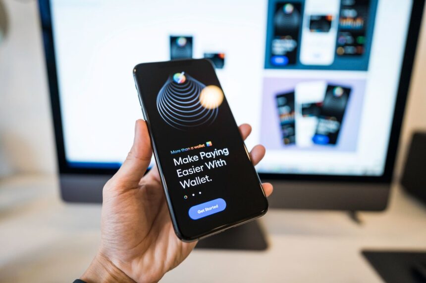 Fintech careers – hand holding a smartphone showing a digital wallet app