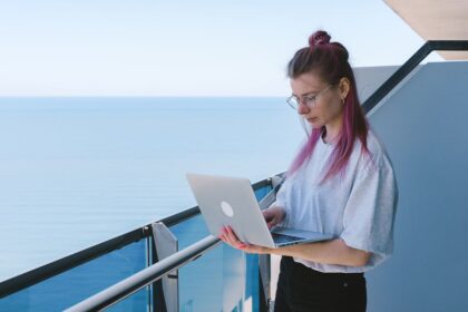 FIRE for Gen Z – young woman working remotely on a laptop by the sea