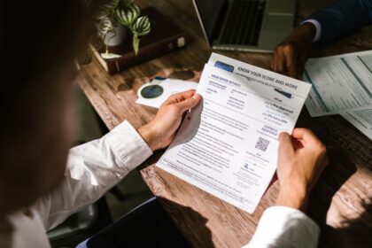 Fix bad credit – man reviewing a financial document at his desk