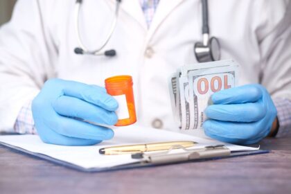 HSA – hands holding a pill bottle and cash, showing medical expenses