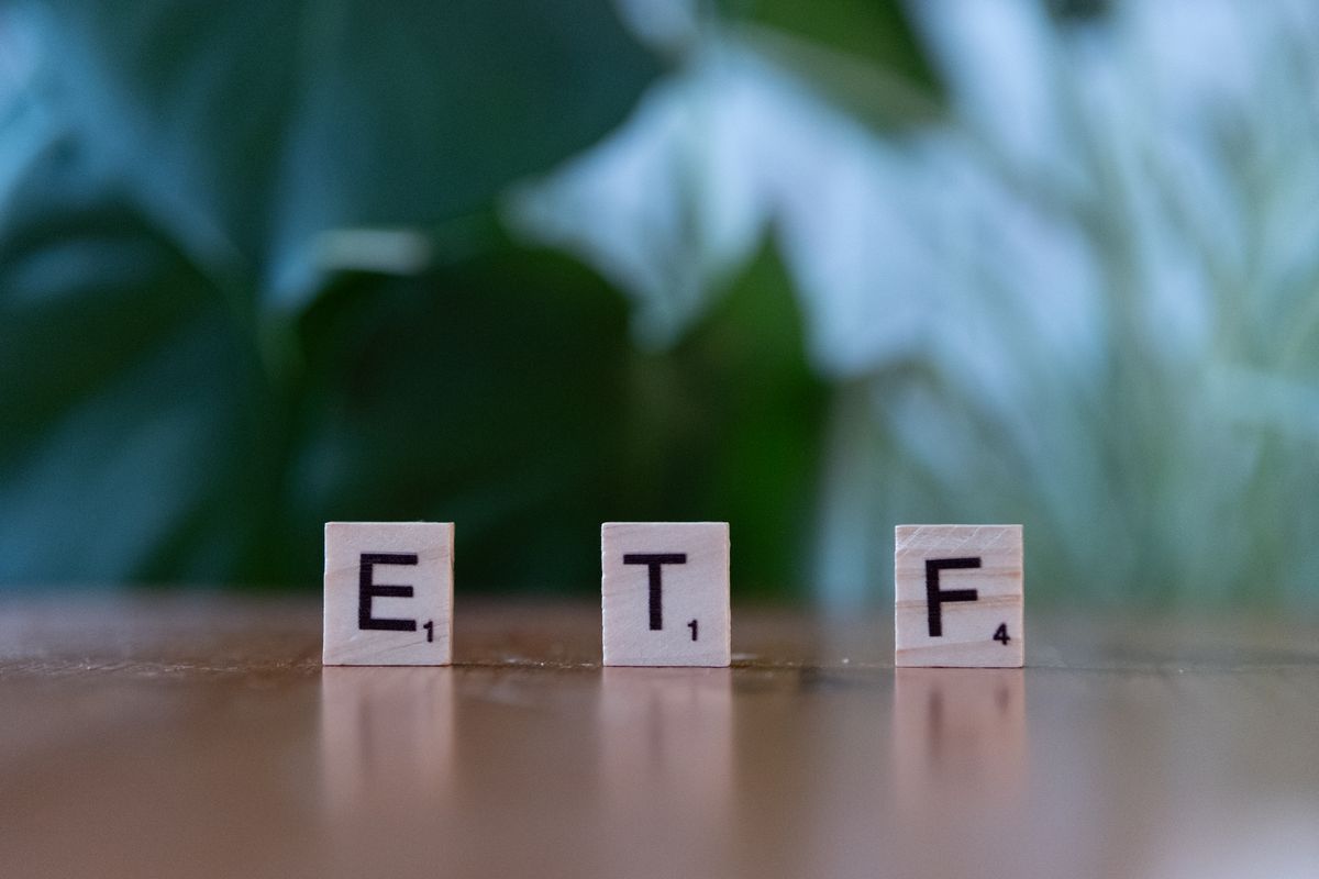 Index funds – scrabble tiles spelling ETF on a wooden table