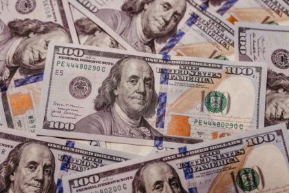 Invest with $100 – stack of 100 dollar US banknotes