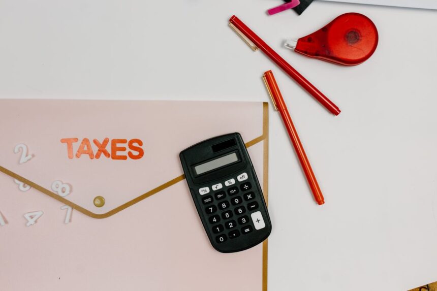 Quarterly estimated taxes – calculator, pens and a folder labeled Taxes