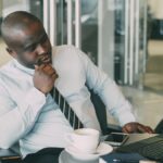 Register a business name in Nigeria – businessman working on a laptop at his desk