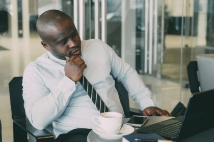 Register a business name in Nigeria – businessman working on a laptop at his desk