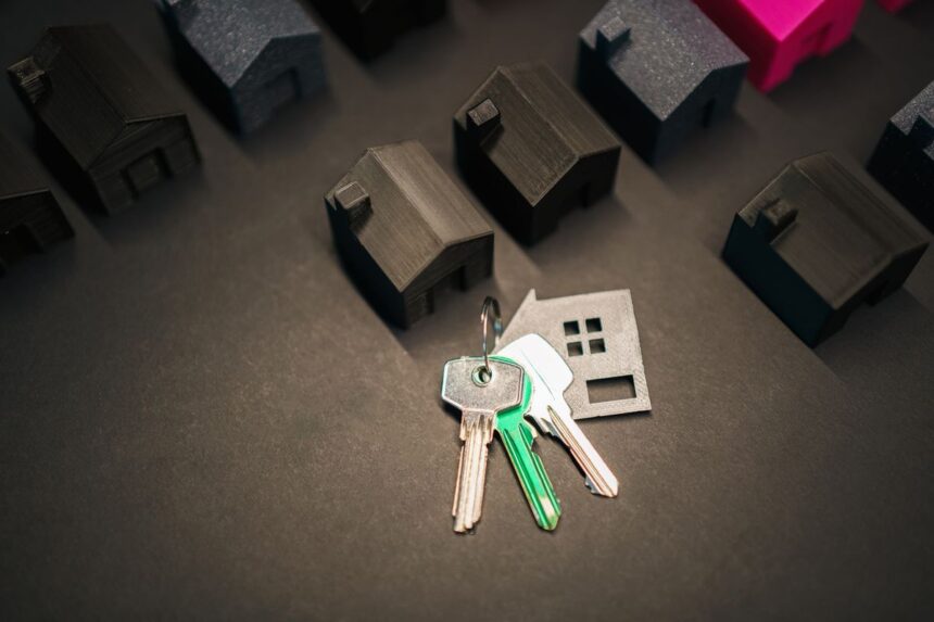 Rent vs buy – miniature house models and keys representing the housing market