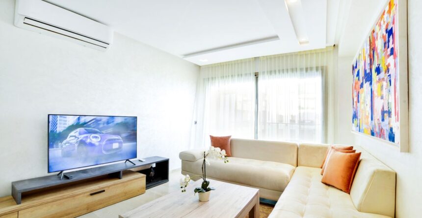 Renters insurance – bright rented living room with sofa, TV and modern decor