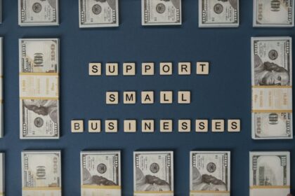 Small business grant – dollar bills and letter tiles promoting small businesses