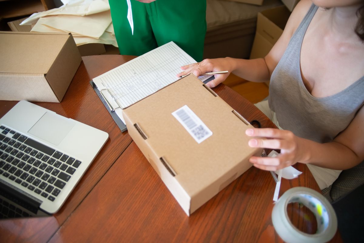 Start an online store – two people packing online orders in a small business