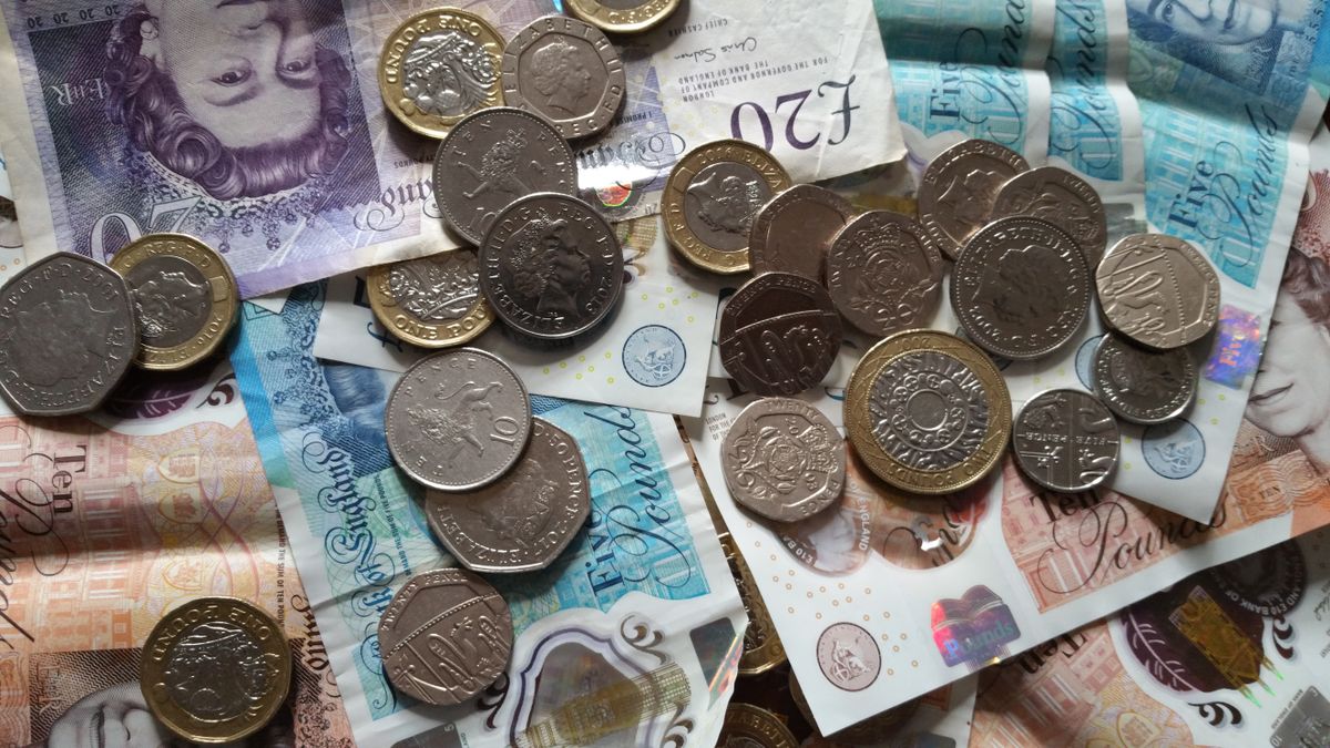 Stocks and shares ISA – british pound coins and banknotes
