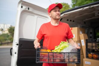 Taxes for delivery drivers – delivery driver carrying groceries from a van