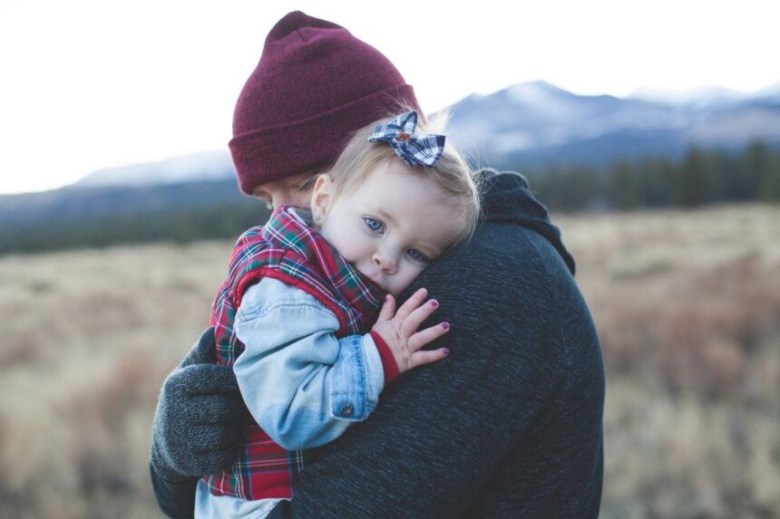 Term vs whole life insurance – father holding his child outdoors