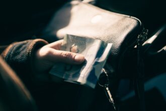 TFSA vs RRSP – person holding a Canadian five-dollar bill